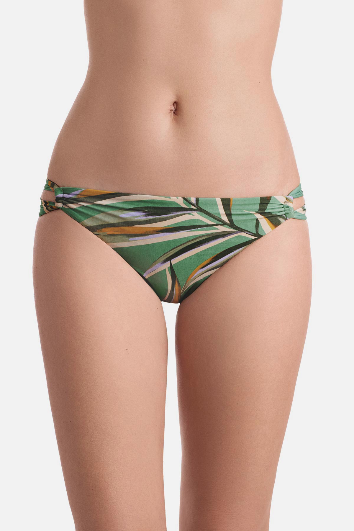 Front view of multicolored leaf printed swim bottoms with side cutouts